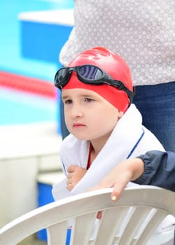 Swimmer with swimming cap and goggles waiting for her start