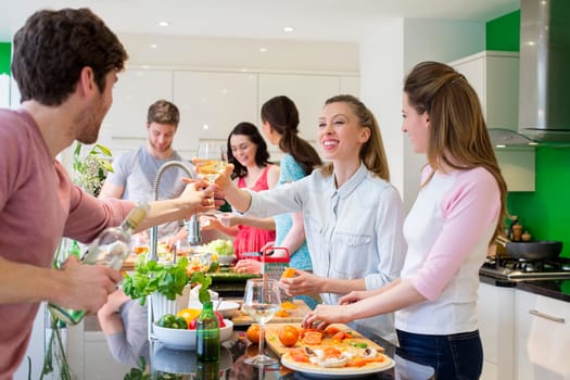A group of friends are preparing a meal together in the kitchen