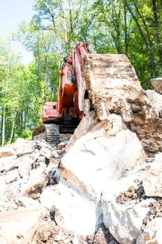 Excavator with big shovel to work with rocks