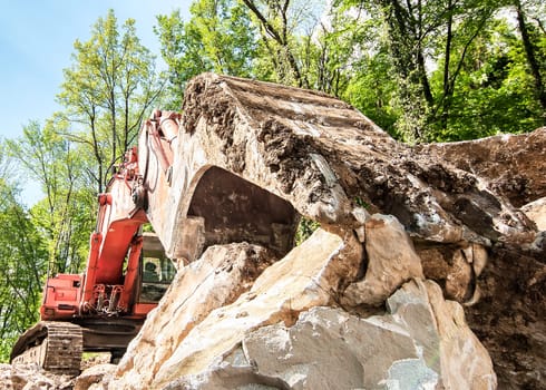 Excavator with big shovel to work with rocks