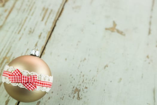 Decorated Christmas balls on a rustic wooden board at Christmas time with text free space