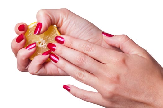 Hand crushed with perfectly lacquered red fingernails A lemon on white hindging