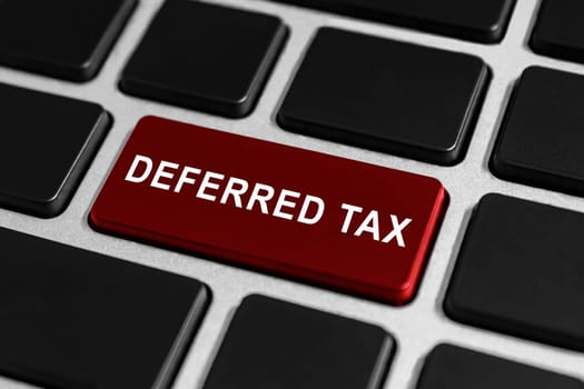 deferred tax red button on keyboard, business concept