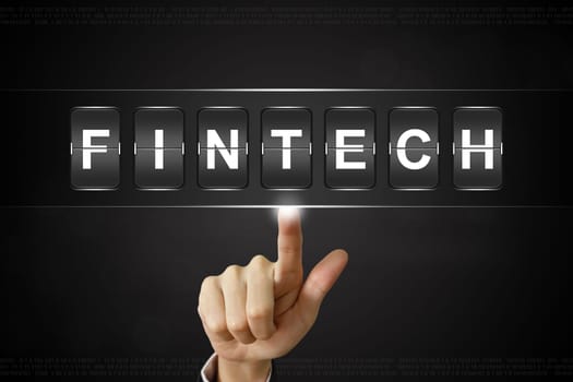 business hand pushing fintech or financial technology on Flipboard Display