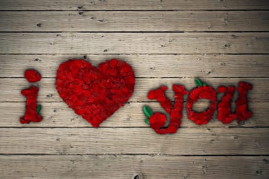 I Love You message of red rose petals on wooden table.