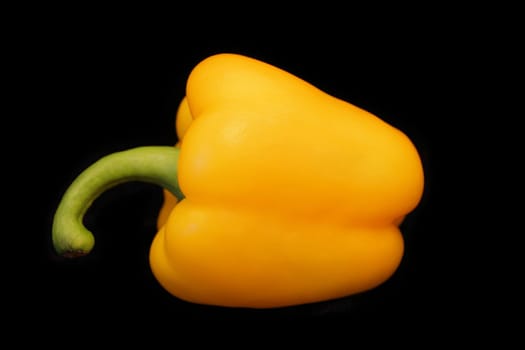 Image of yellow raw pepper on black background