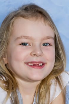 Portrait of smiling toothless girl with blond hair