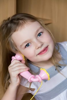 Portrait of beautiful girl with pink telephone