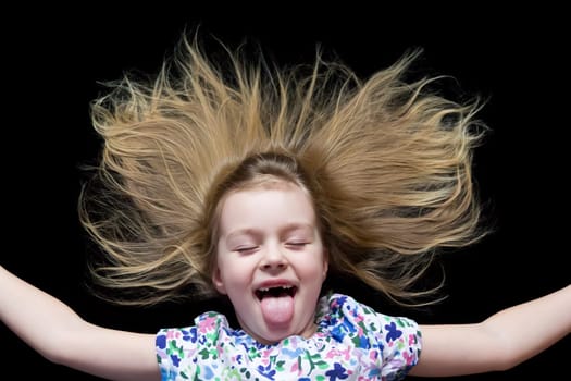 Girl makes faces imitate witch and put out tongue