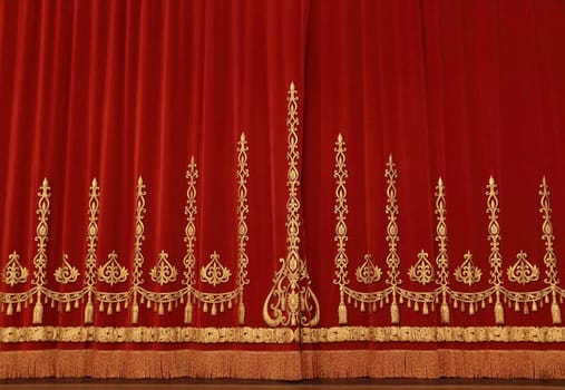 Theatrical red velvet curtain with gold pattern
