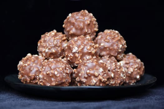Image of brown sweet candy on black background