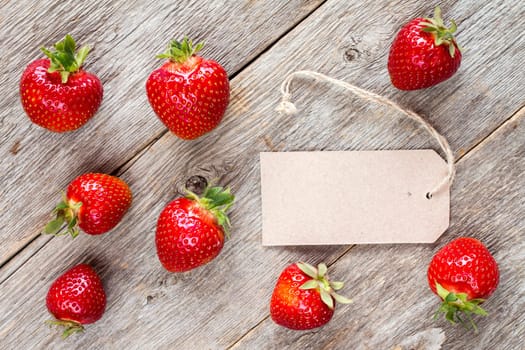 Red strawberries and blank tag tied with string