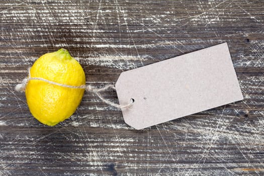 Fresh lemon with  blank cardboard information tag