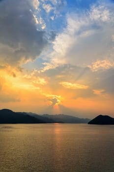 Beautiful landscape during sunset over a mountain ranges at lake in Srinakarin Dam, Kanchanaburi Province, Thailand