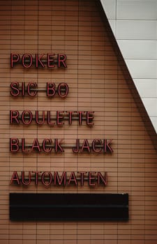 The illuminated signs of a casino with different game offers.
