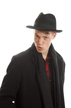 A charming young man in a coat and with a fedora