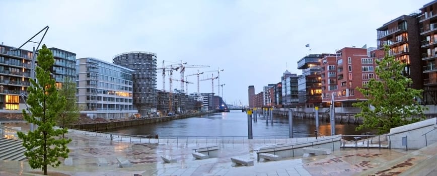 Hamburg, Germany - May 25, 2008: Hamburg Hafencity panorama on a rainy day. Channel in foreground surrounded by modern brick buildings