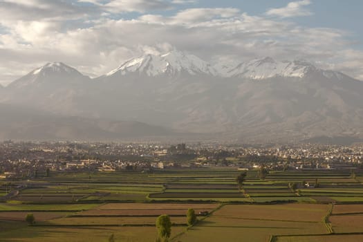 City of Arequipa, Peru with its iconic fields and volcano Chachani in the background