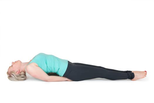 Full body view of a young blonde woman doing yoga exercises against a white background with a slight shadow