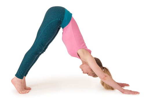 Full body view of a young blonde woman doing yoga exercises against a white background with a slight shadow