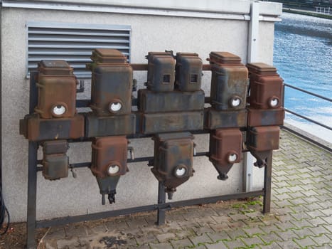 old electrical connection boxes on white wall