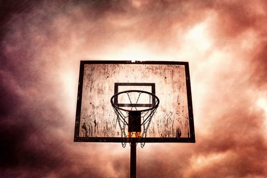 Old disused outdoor basketball hoop on a stormy, cloudy day