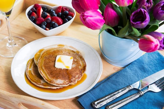 Fresh fruit and pancakes along with tulips for a wonderful brunch.