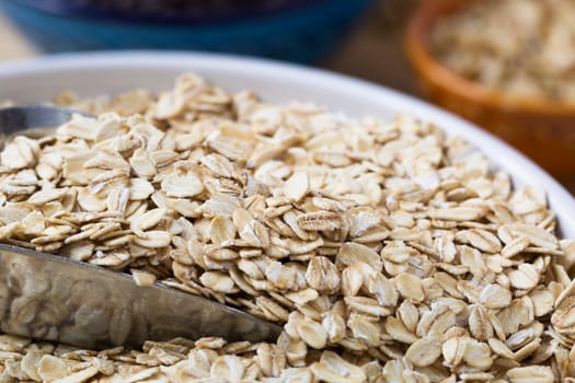 Healthy raw oats with scoop closeup.