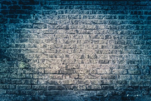 Dark blue grungy bricked wall textured background