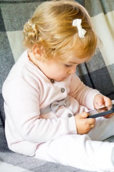 Cute baby girl with new mobile phone