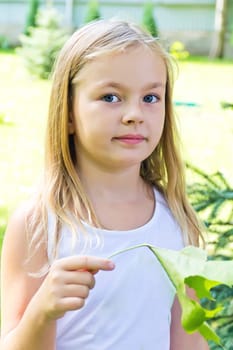 Cute girl with blond long hair and blue eyes