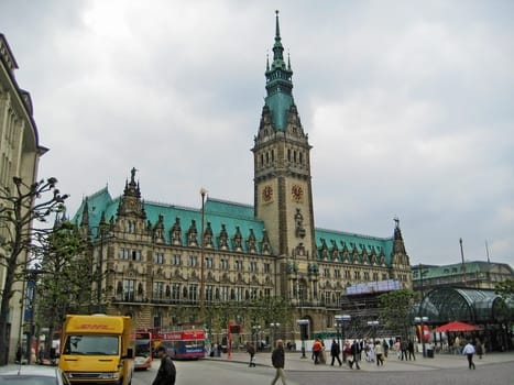 Hamburg, Germany - May 26, 2008: Town hall of Hamburgperspective view. People walking in front of the historic building.