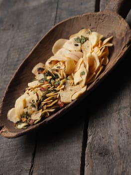 Old used wooden shovel with dried garlic and spicy herbs, cooking ingredients concept image