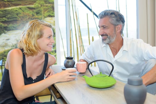 Man and lady enjoying a hot drink together