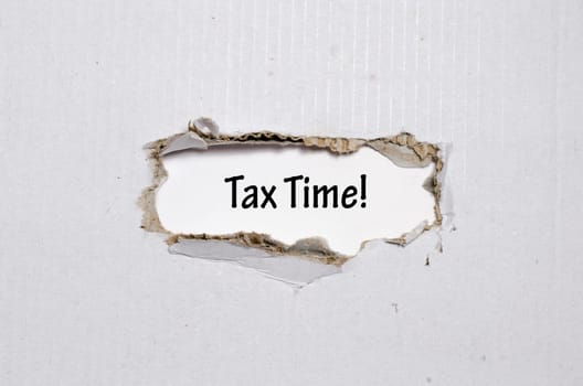The word tax time appearing behind torn paper