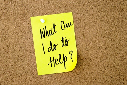 What Can I Do To Help ? written on yellow paper note pinned on cork board with white thumbtacks, copy space available