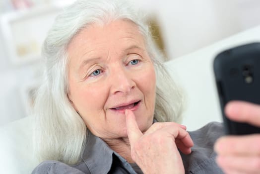 Senior lady reading a text message