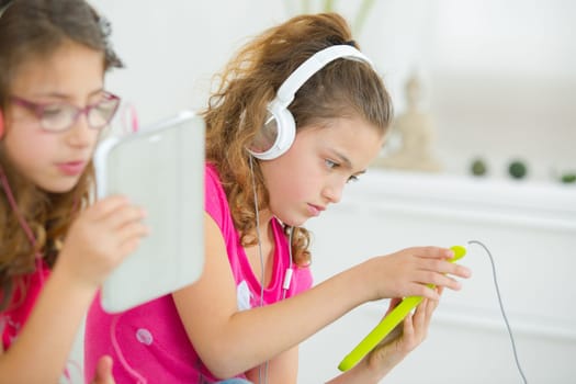 Little girls with tablet computers