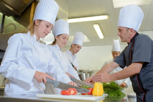 Chef teaching students on catering course