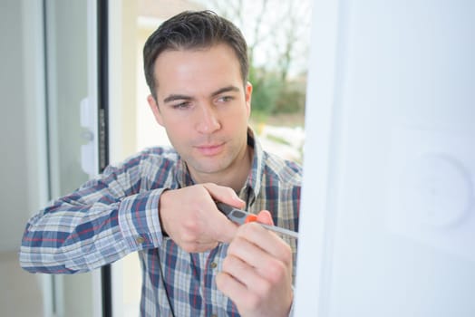 Handyman fitting a new door