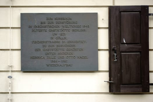 Berlin,Germany - June 21,2016: The memorial plaque of Berlin's oldest restaurant,Zum Nussbaum on a nostalgic façade in the Nikolaiviertel on June 21,2016 in Berlin.