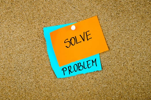 Solve Problem written on paper notes pinned on cork board with white thumb tack, copy space available