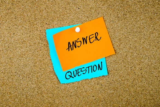 Answer Question written on paper notes pinned on cork board with white thumb tack, copy space available