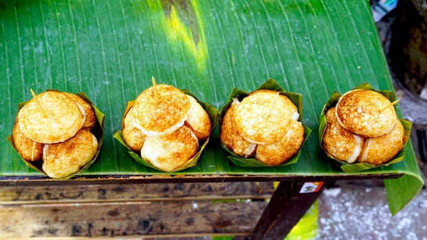 Sweet and Savory Grilled Coconut-Rice Hotcakes, Coconut Rice Cake on banana packaging, Asian dessert, Thai, Thailand, Luang Prabang, Laos