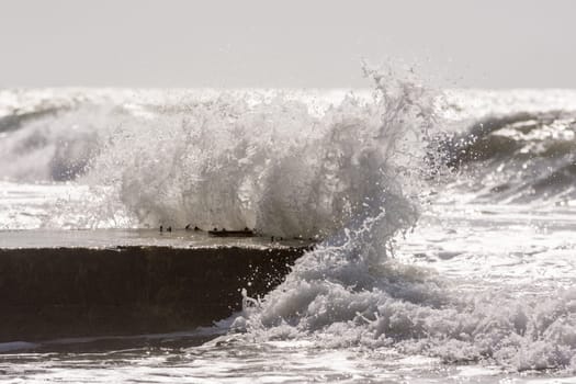 Waves breaking on the concrete pier