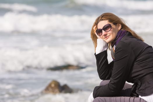 Happy girl with glasses on the background of the sea