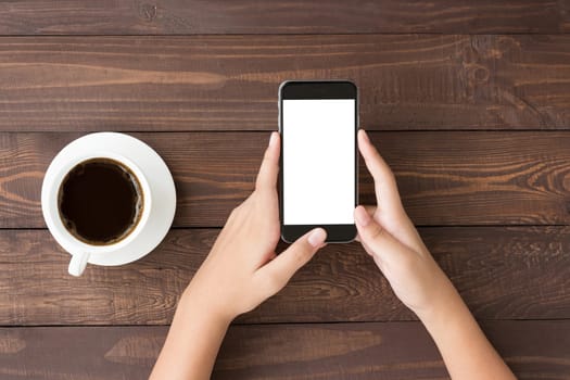 phone white screen in woman hand on table top view