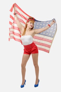 pretty young woman with an American flag isolated on white background