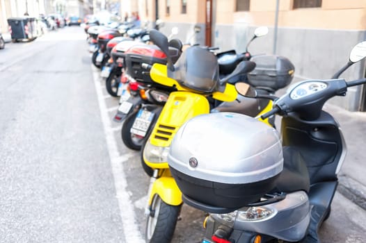 Trieste ,Italy - April 22 2016 : Motorbike, motorcycle scooters parked in row in city street.