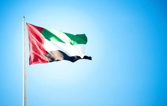 United Arab Emirates flag flying against clean and tranquil sky